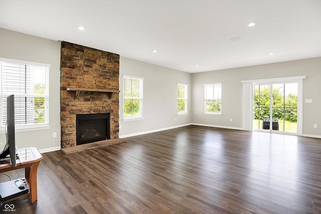 13567 Moorcroft Dr, Fishers, IN 46037 - unfurnished living room featuring plenty of natural light, a stone fireplace, dark wood-style flooring, and recessed lighting