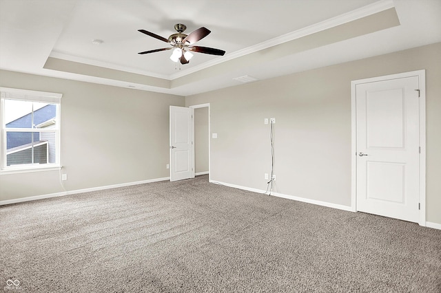 13567 Moorcroft Dr, Fishers, IN 46037 - carpeted spare room featuring a tray ceiling, ceiling fan, crown molding, and baseboards