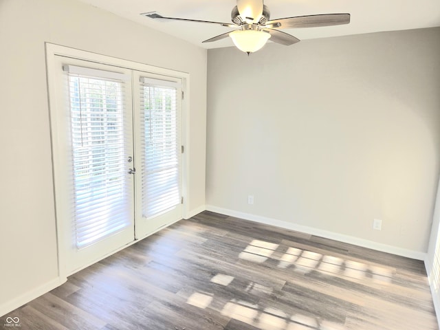 2465 N Eaton Ave, Indianapolis, IN 46219 - empty room with french doors, a ceiling fan, dark wood-style floors, and baseboards