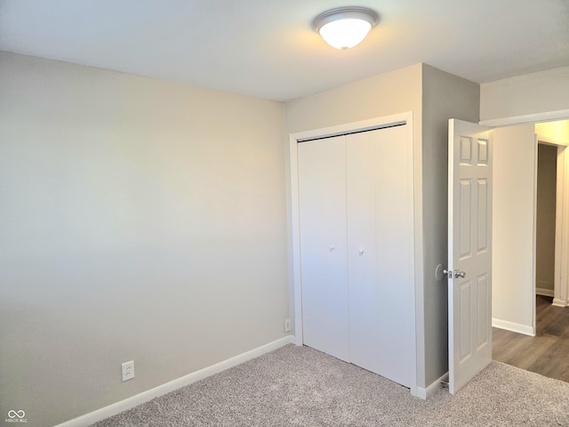 2465 N Eaton Ave, Indianapolis, IN 46219 - unfurnished bedroom featuring a closet, baseboards, and carpet