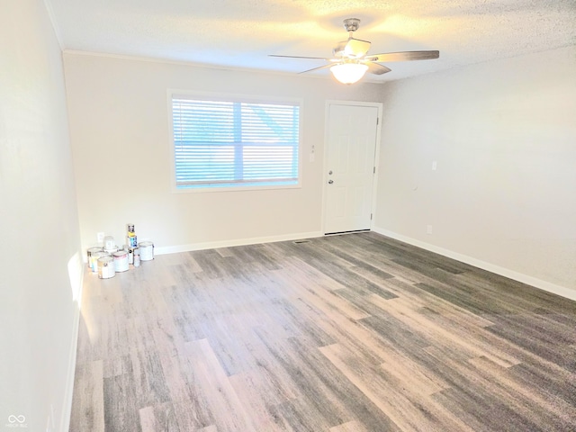 2465 N Eaton Ave, Indianapolis, IN 46219 - unfurnished room featuring wood finished floors, ceiling fan, baseboards, and a textured ceiling
