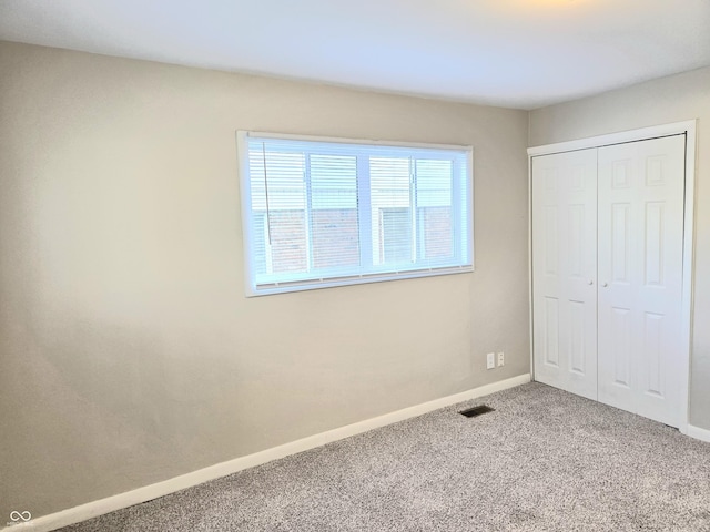 2465 N Eaton Ave, Indianapolis, IN 46219 - unfurnished bedroom with carpet, a closet, and baseboards