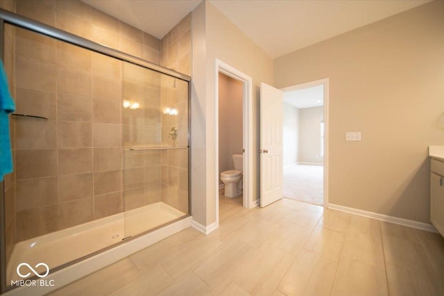 9455 Orchard Cove Dr, Indianapolis, IN 46239 - full bathroom with vanity, baseboards, a stall shower, and toilet