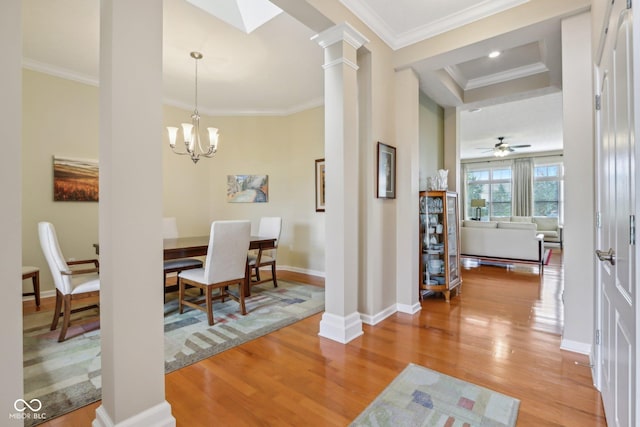 1361 Trescott Dr, Westfield, IN 46074 - dining area featuring light wood-style floors, decorative columns, crown molding, baseboards, and a chandelier