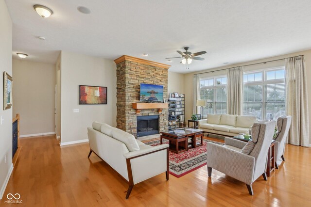 1361 Trescott Dr, Westfield, IN 46074 - living room with a fireplace, ceiling fan, light wood finished floors, and baseboards
