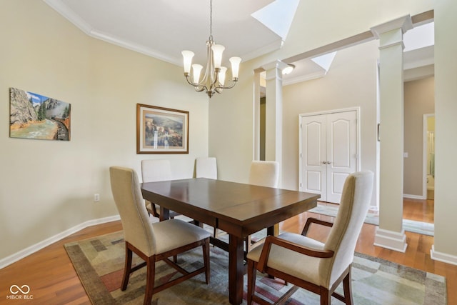 1361 Trescott Dr, Westfield, IN 46074 - dining room featuring decorative columns, ornamental molding, wood finished floors, a chandelier, and baseboards