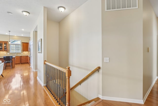 1361 Trescott Dr, Westfield, IN 46074 - corridor featuring an upstairs landing, light wood-type flooring, a sink, and baseboards