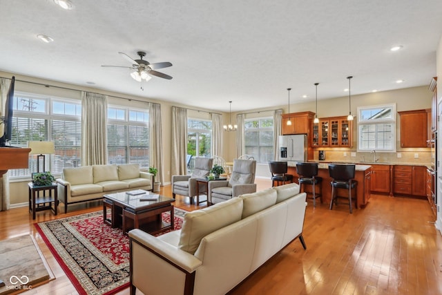 1361 Trescott Dr, Westfield, IN 46074 - living area featuring ceiling fan, light wood-type flooring, recessed lighting, and a chandelier
