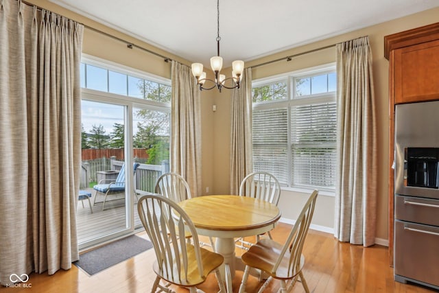 1361 Trescott Dr, Westfield, IN 46074 - dining room featuring a chandelier, light wood-style flooring, and healthy amount of natural light