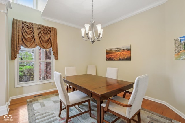 1361 Trescott Dr, Westfield, IN 46074 - dining area with wood finished floors, ornamental molding, a chandelier, and baseboards