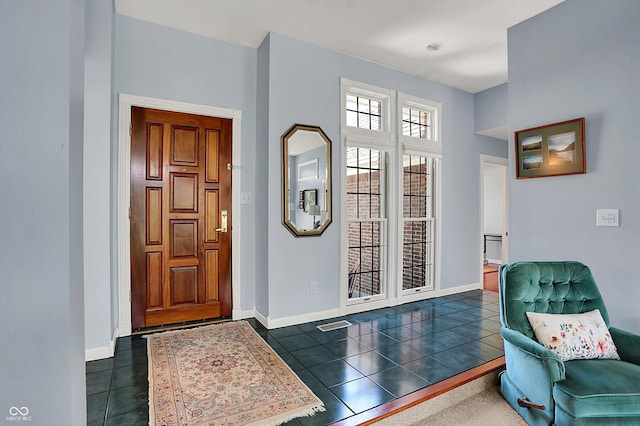 424 Orchard Blvd, Danville, IN 46122 - entryway featuring visible vents, baseboards, and dark tile patterned floors
