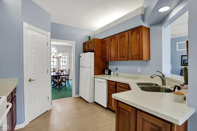424 Orchard Blvd, Danville, IN 46122 - kitchen with a sink, a notable chandelier, white appliances, brown cabinetry, and light countertops