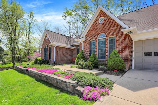 424 Orchard Blvd, Danville, IN 46122 - exterior space featuring roof with shingles, concrete driveway, brick siding, a front yard, and a garage