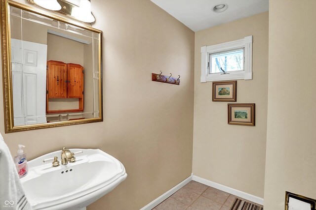 424 Orchard Blvd, Danville, IN 46122 - bathroom with tile patterned floors, baseboards, and a sink