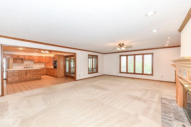 unfurnished living room featuring baseboards, light colored carpet, and a fireplace