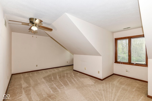 bonus room featuring carpet flooring, a ceiling fan, visible vents, and lofted ceiling