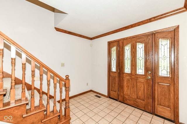 entrance foyer featuring visible vents, crown molding, stairs, and baseboards