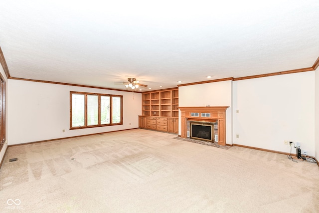 unfurnished living room featuring light colored carpet, visible vents, ornamental molding, and baseboards
