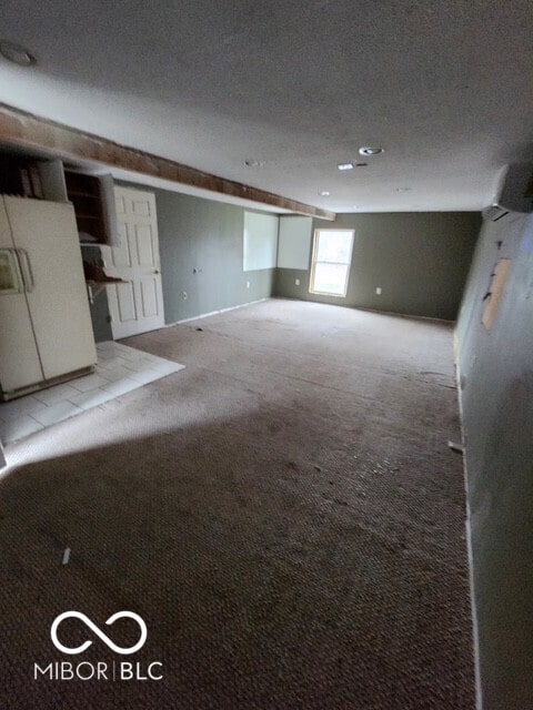 interior space featuring carpet floors and a textured ceiling