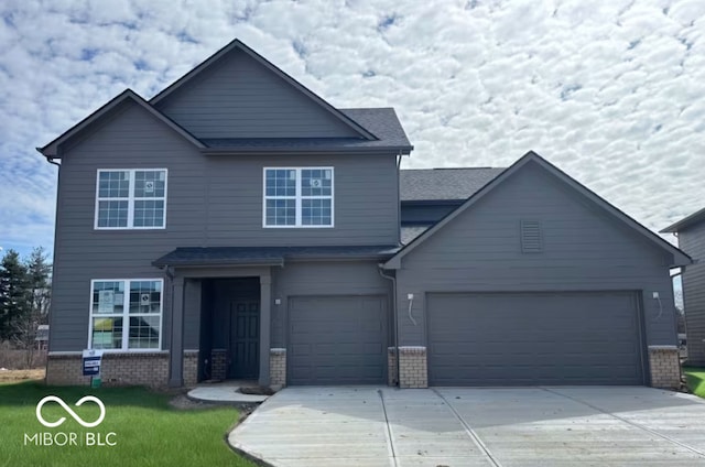 craftsman-style home featuring driveway, roof with shingles, an attached garage, and brick siding