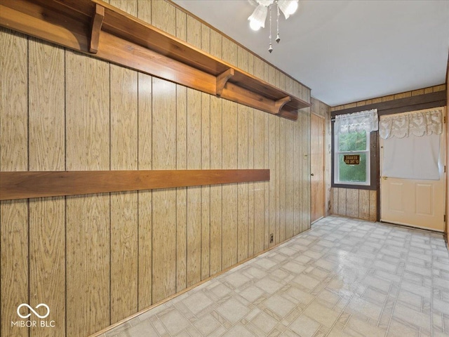 315 E N St, Greensburg, IN 47240 - spare room with wood walls, tile patterned floors, and a ceiling fan