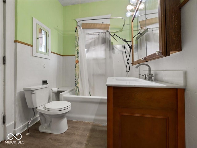 315 E N St, Greensburg, IN 47240 - full bathroom with vanity, wood finished floors, shower / bath combo with shower curtain, tile walls, and wainscoting