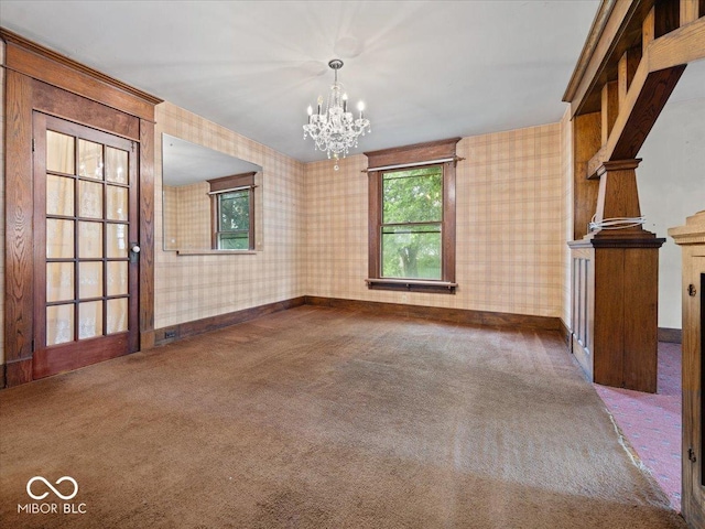 315 E N St, Greensburg, IN 47240 - unfurnished dining area with wallpapered walls, a chandelier, and carpet flooring