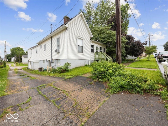 315 E N St, Greensburg, IN 47240 - view of home's exterior featuring a chimney and an attached garage