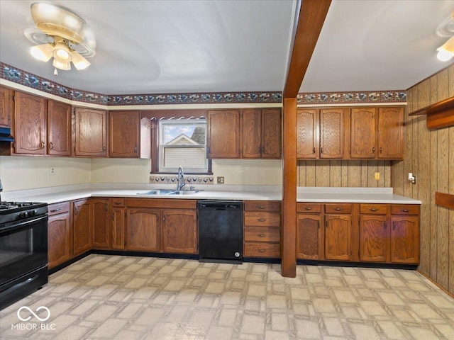 315 E N St, Greensburg, IN 47240 - kitchen featuring black appliances, light countertops, wood walls, ceiling fan, and under cabinet range hood