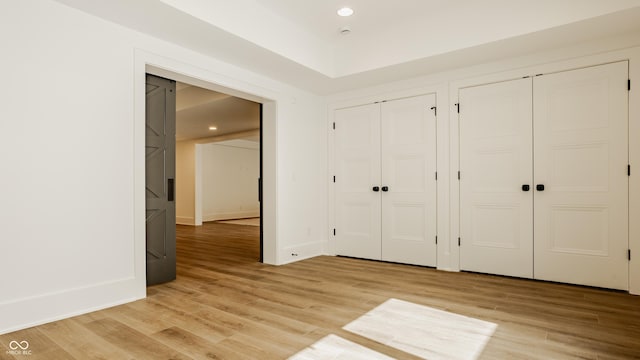8082 Abington Way, Zionsville, IN 46077 - unfurnished bedroom with recessed lighting, light wood-style flooring, multiple closets, and baseboards