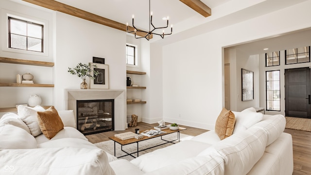 8082 Abington Way, Zionsville, IN 46077 - living area with wood finished floors, a healthy amount of sunlight, beam ceiling, and a notable chandelier
