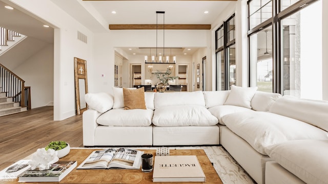 8082 Abington Way, Zionsville, IN 46077 - living area with a notable chandelier, visible vents, light wood-style floors, and stairs