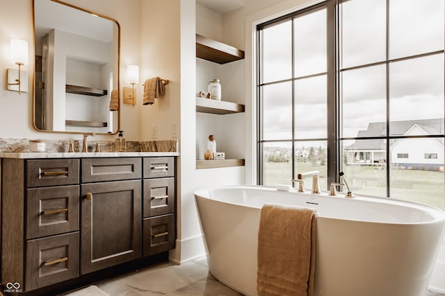 8082 Abington Way, Zionsville, IN 46077 - full bath featuring marble finish floor, a freestanding tub, built in shelves, and vanity