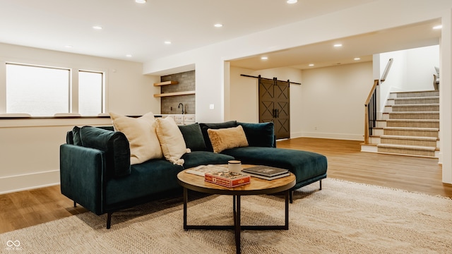 8082 Abington Way, Zionsville, IN 46077 - living room with a barn door, stairs, light wood-type flooring, indoor wet bar, and recessed lighting