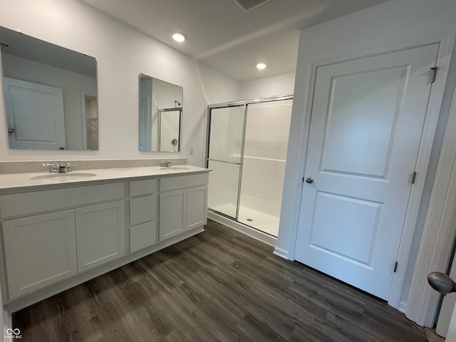 1319 Fleming Dr, Greenfield, IN 46140 - bathroom with a shower stall, wood finished floors, double vanity, and recessed lighting