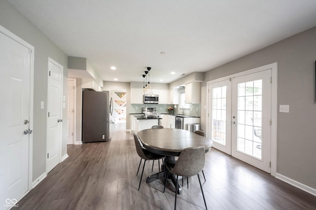 dining room featuring french doors, dark wood-type flooring, baseboards, and recessed lighting