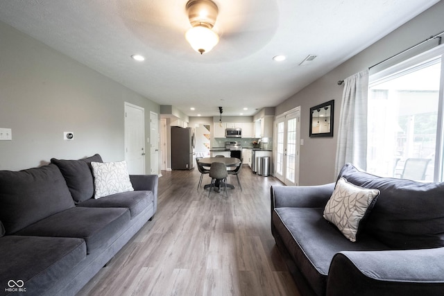 living area featuring wood finished floors and recessed lighting