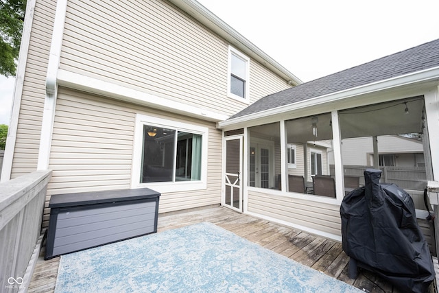 wooden terrace featuring a sunroom and grilling area