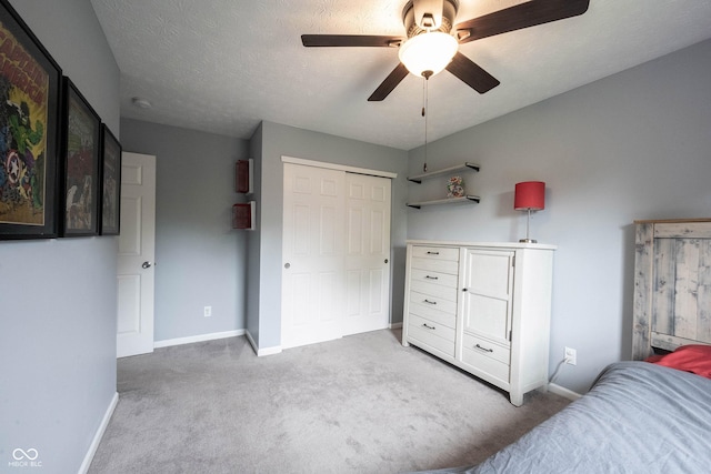 bedroom featuring carpet floors, baseboards, a closet, and a ceiling fan