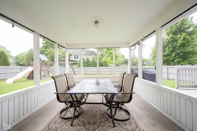 sunroom with outdoor dining area