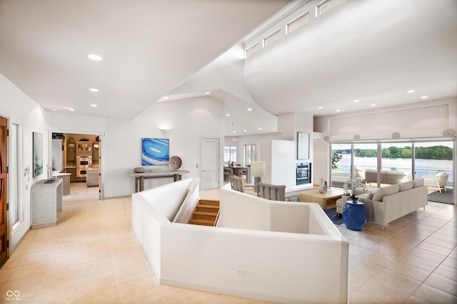 10919 Brigantine Dr, Indianapolis, IN 46256 - living area featuring recessed lighting, a water view, a high ceiling, and light tile patterned floors
