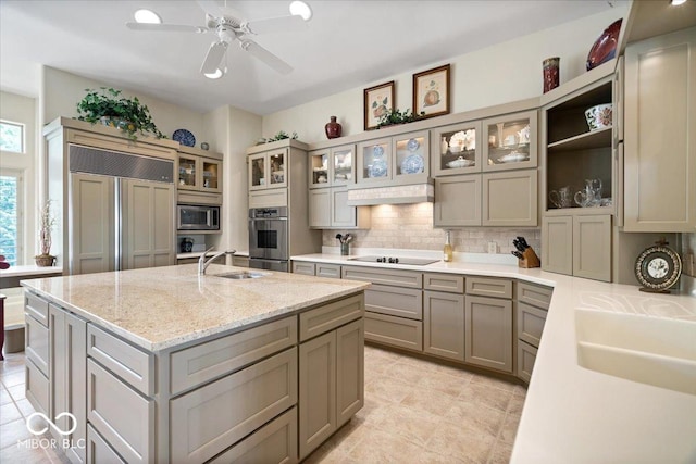 10919 Brigantine Dr, Indianapolis, IN 46256 - kitchen with tasteful backsplash, a sink, built in appliances, a center island with sink, and gray cabinetry