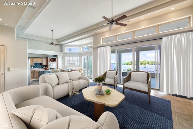 10919 Brigantine Dr, Indianapolis, IN 46256 - living area featuring recessed lighting, a towering ceiling, a water view, a ceiling fan, and light tile patterned flooring