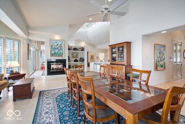 10919 Brigantine Dr, Indianapolis, IN 46256 - dining space with high vaulted ceiling, a ceiling fan, a multi sided fireplace, light tile patterned flooring, and recessed lighting