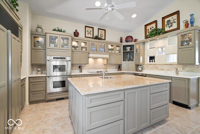 10919 Brigantine Dr, Indianapolis, IN 46256 - kitchen with double oven, backsplash, a ceiling fan, and a sink