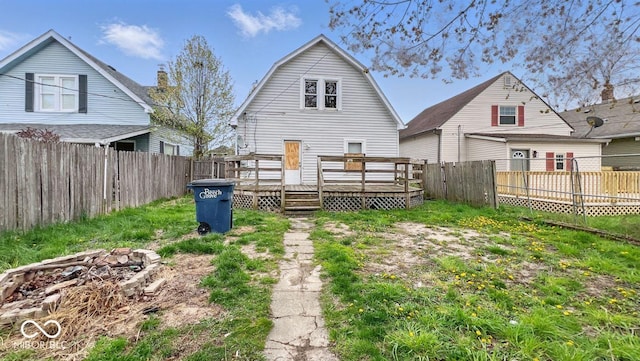 back of house with a fenced backyard, a wooden deck, and a gambrel roof