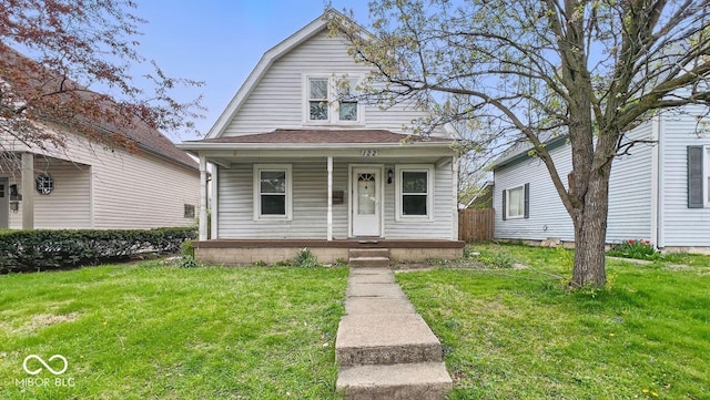 dutch colonial featuring a gambrel roof, a front yard, and covered porch