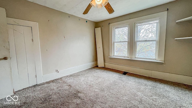 empty room featuring carpet and a ceiling fan