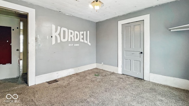 carpeted spare room with baseboards