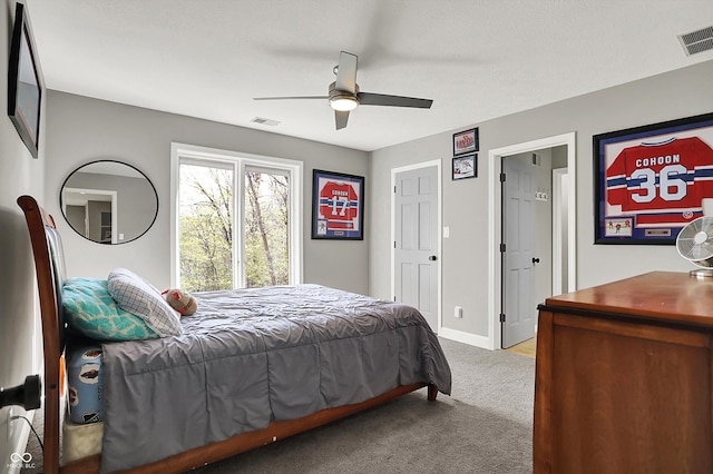 carpeted bedroom with ceiling fan, visible vents, and baseboards